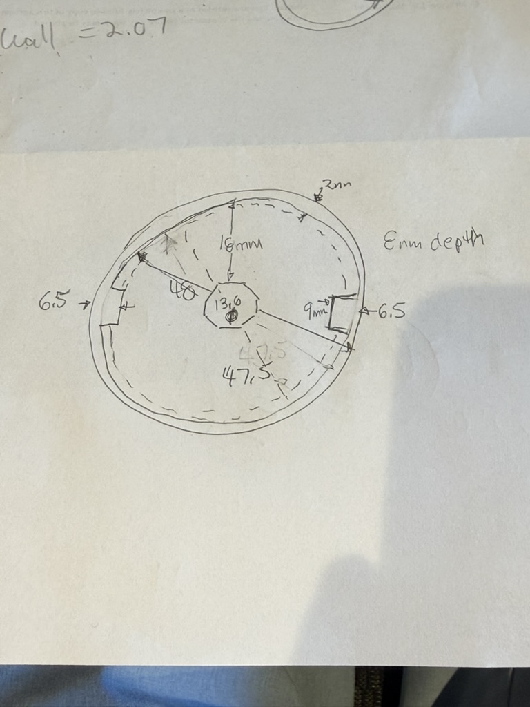Hand-drawn cross-section sketch of the escutcheon cavity with measured dimensions, including wall thickness, depth, and nub geometry